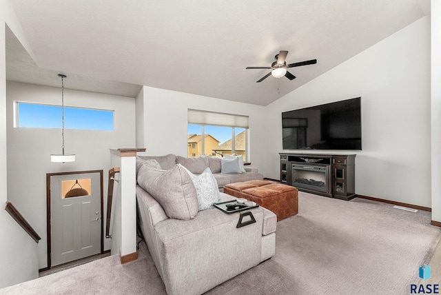 9400 W Colton St, Sioux Falls, SD 57106 - living room with a ceiling fan, carpet flooring, a glass covered fireplace, and vaulted ceiling