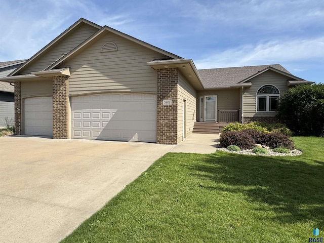 3908 W 89th St, Sioux Falls, SD 57108 - ranch-style house featuring brick siding, a garage, concrete driveway, and a front lawn