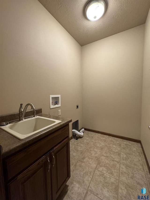 3908 W 89th St, Sioux Falls, SD 57108 - washroom featuring electric dryer hookup, hookup for a washing machine, cabinet space, a textured ceiling, and light tile patterned floors