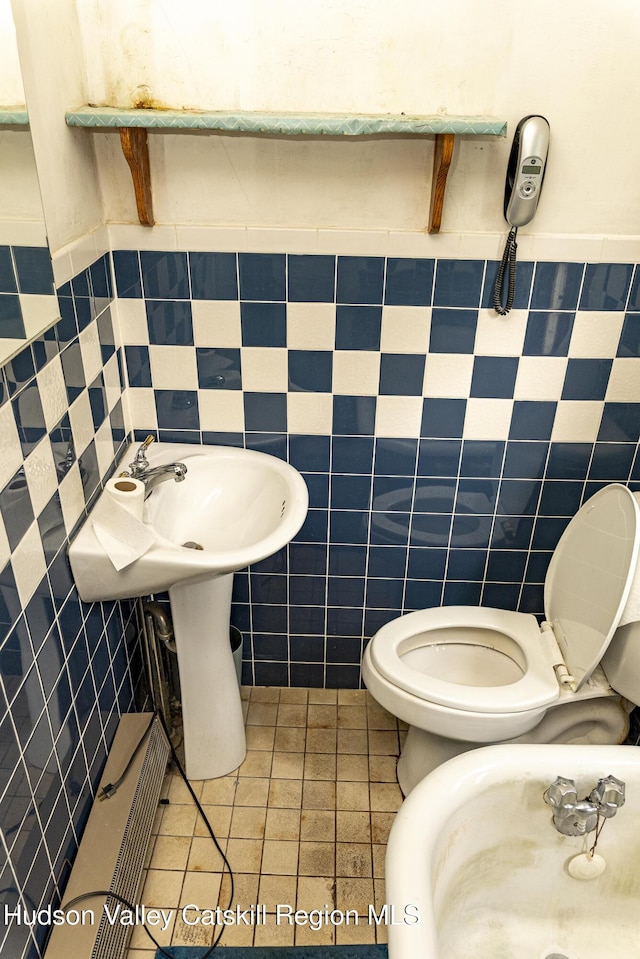 53 Broad St, Catskill, NY 12414 - bathroom with tile walls, a wainscoted wall, and tile patterned flooring