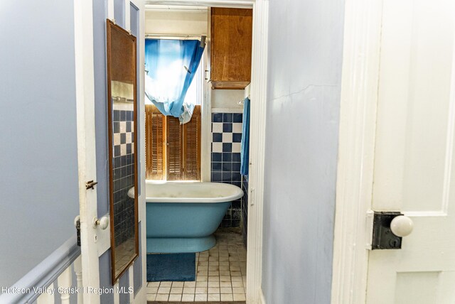 53 Broad St, Catskill, NY 12414 - full bath with a freestanding bath, tile walls, tile patterned flooring, and a wainscoted wall
