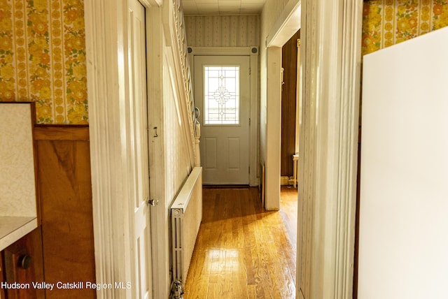 53 Broad St, Catskill, NY 12414 - hallway featuring wallpapered walls, wood finished floors, and radiator heating unit