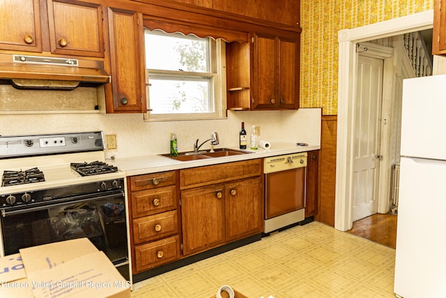 53 Broad St, Catskill, NY 12414 - kitchen with freestanding refrigerator, range with gas stovetop, dishwasher, under cabinet range hood, and wallpapered walls