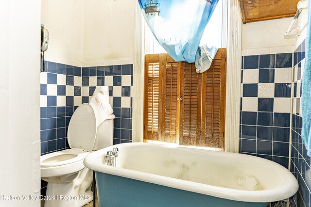 53 Broad St, Catskill, NY 12414 - bathroom featuring tile walls and a soaking tub