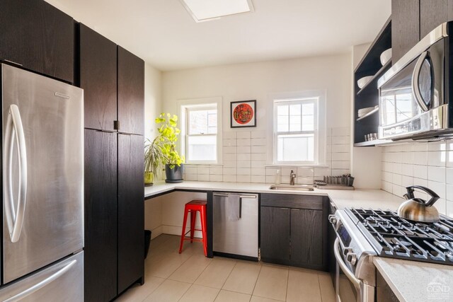 705 Warren St, Hudson, NY 12534 - kitchen featuring appliances with stainless steel finishes, a sink, light countertops, and decorative backsplash