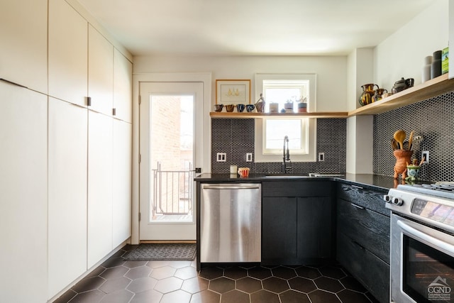 705 Warren St, Hudson, NY 12534 - kitchen with open shelves, stainless steel appliances, dark countertops, and decorative backsplash