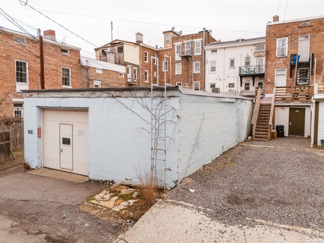 705 Warren St, Hudson, NY 12534 - back of house featuring stairway, an outdoor structure, and a residential view