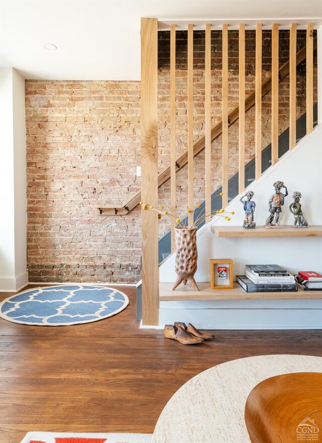 705 Warren St, Hudson, NY 12534 - detailed view of brick wall, wood finished floors, and baseboards