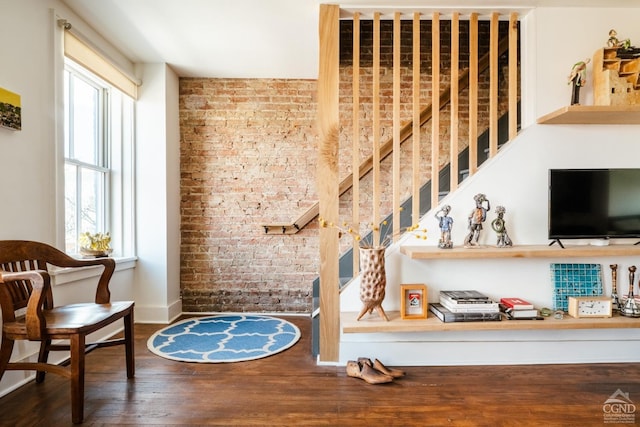 705 Warren St, Hudson, NY 12534 - interior space featuring brick wall, wood finished floors, and baseboards