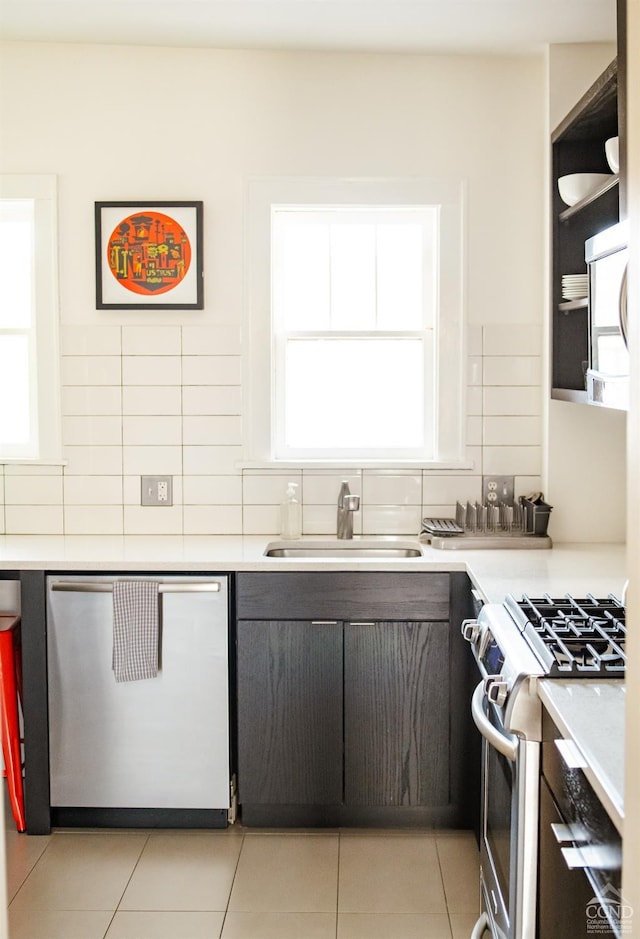705 Warren St, Hudson, NY 12534 - kitchen with appliances with stainless steel finishes, a sink, healthy amount of natural light, and tasteful backsplash