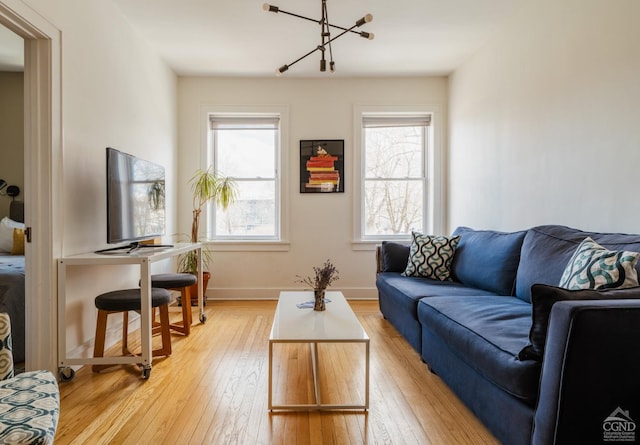 705 Warren St, Hudson, NY 12534 - living room with light wood-style floors, healthy amount of natural light, and baseboards