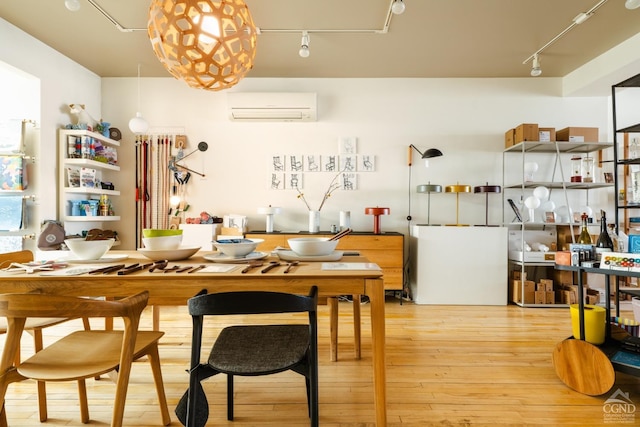 705 Warren St, Hudson, NY 12534 - kitchen featuring a wall mounted air conditioner, track lighting, and hardwood / wood-style flooring