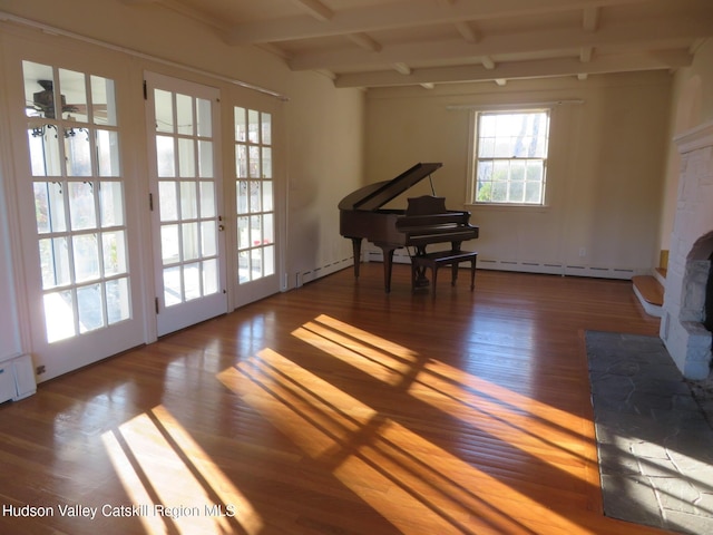 miscellaneous room with beam ceiling, french doors, and wood-type flooring