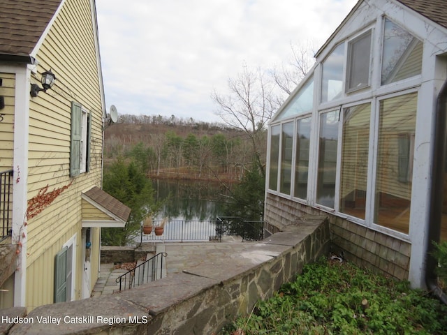 view of property exterior featuring a sunroom