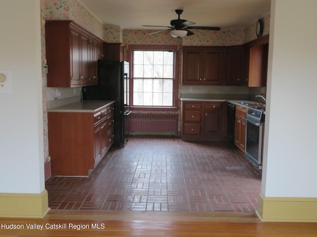 kitchen with radiator, black appliances, and ceiling fan