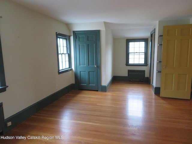 empty room featuring hardwood / wood-style flooring and radiator