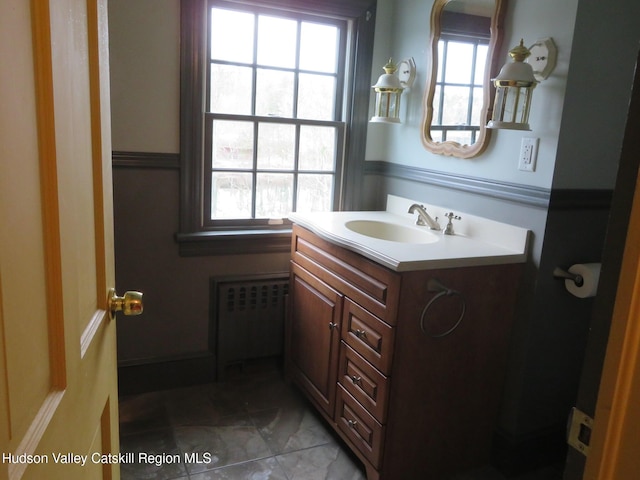 bathroom with plenty of natural light, vanity, and radiator