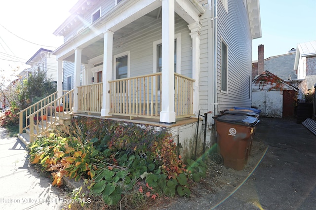 view of side of home with covered porch