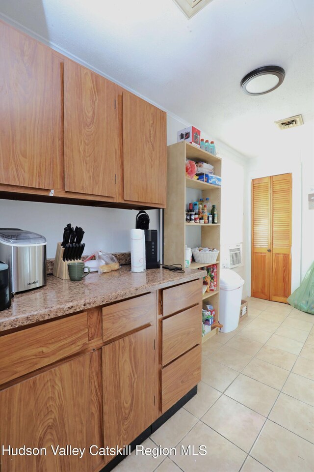 kitchen with light stone countertops and light tile patterned flooring