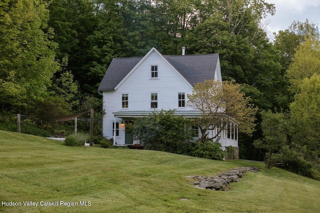 1556 Gulf Rd, Callicoon Center, NY 12724 - view of front of property with a front yard, a shingled roof, and a forest view