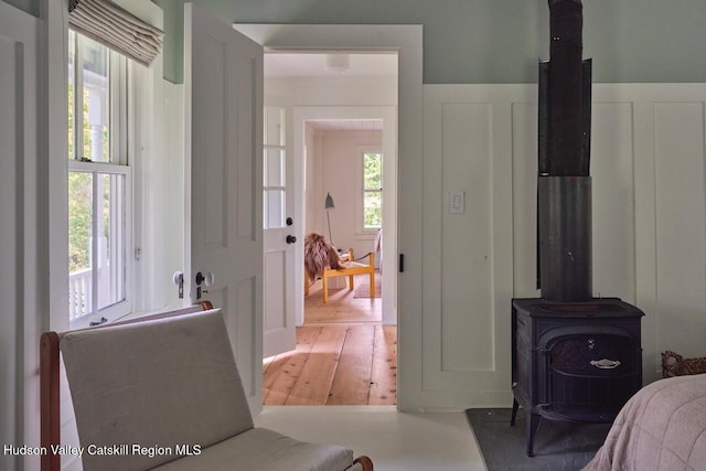 1556 Gulf Rd, Callicoon Center, NY 12724 - bedroom with a wood stove and hardwood / wood-style flooring