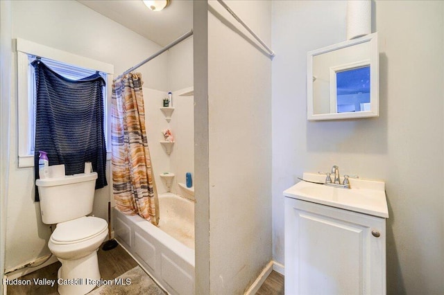 bathroom with shower / bath combo, baseboards, toilet, wood finished floors, and vanity
