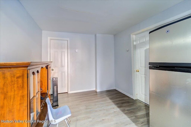 interior space with wood finished floors and baseboards