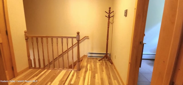 69 June Lodge Dr, Hunter, NY 12442 - stairway featuring a baseboard radiator and wood finished floors