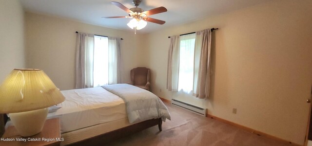 69 June Lodge Dr, Hunter, NY 12442 - bedroom with a baseboard heating unit, multiple windows, light carpet, and a ceiling fan
