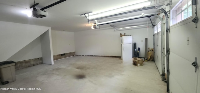 69 June Lodge Dr, Hunter, NY 12442 - garage with a garage door opener and freestanding refrigerator
