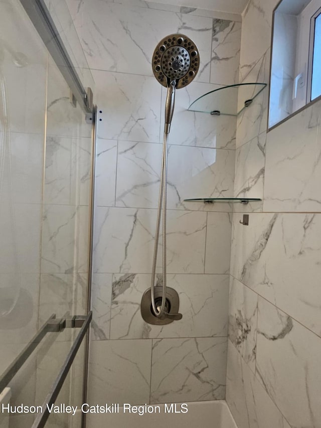 full bathroom with a tile shower