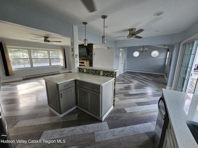 kitchen featuring open floor plan, ceiling fan, a baseboard heating unit, and a baseboard radiator