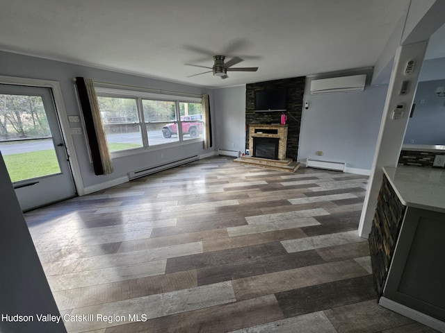 unfurnished living room featuring a ceiling fan, an AC wall unit, a baseboard heating unit, and a baseboard radiator