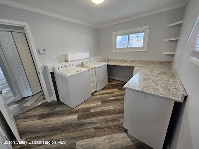 clothes washing area featuring washer and dryer, a healthy amount of sunlight, dark wood-style flooring, and laundry area