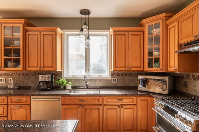 214 Wright Rd, Kerhonkson, NY 12446 - kitchen with stainless steel appliances, under cabinet range hood, decorative backsplash, and brown cabinets