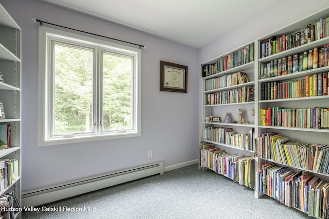 214 Wright Rd, Kerhonkson, NY 12446 - sitting room featuring a baseboard radiator, wall of books, plenty of natural light, and carpet flooring