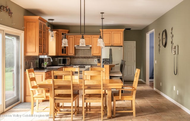 214 Wright Rd, Kerhonkson, NY 12446 - kitchen with backsplash, stainless steel appliances, dark countertops, decorative light fixtures, and glass insert cabinets