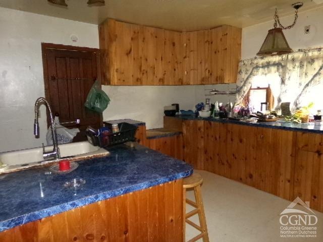 840 Clove Rd, Cobleskill, NY 12043 - kitchen with a sink, brown cabinets, and dark countertops
