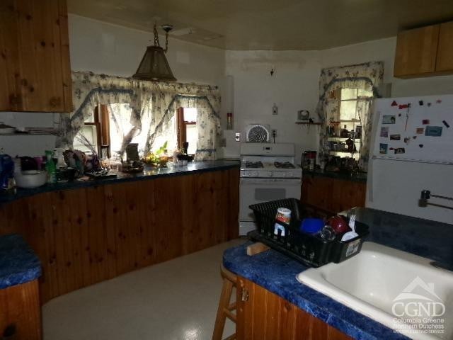 840 Clove Rd, Cobleskill, NY 12043 - kitchen with white appliances and brown cabinets