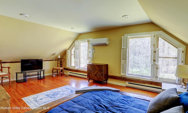 interior space featuring plenty of natural light, a baseboard radiator, lofted ceiling, and baseboard heating