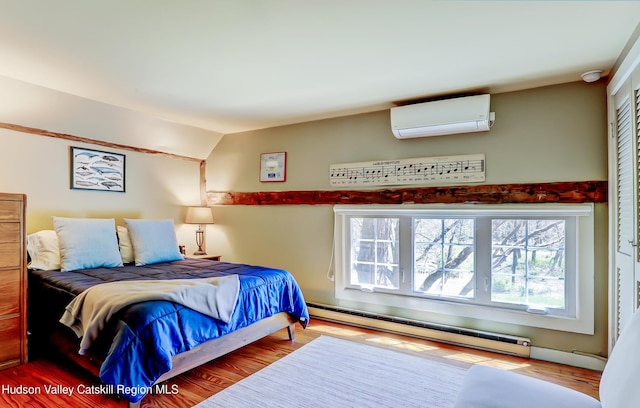 bedroom featuring wood finished floors, a wall mounted air conditioner, lofted ceiling, and a baseboard heating unit