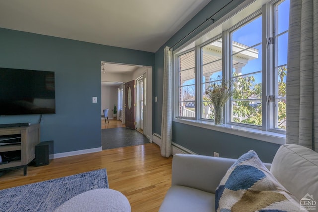 25 Joslen Pl, Hudson, NY 12534 - living area with wood finished floors, baseboards, and a baseboard heating unit