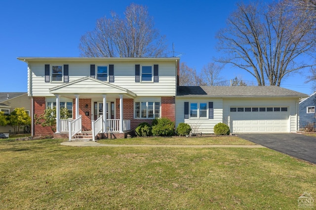 25 Joslen Pl, Hudson, NY 12534 - view of front of house featuring an attached garage, a porch, asphalt driveway, and brick siding