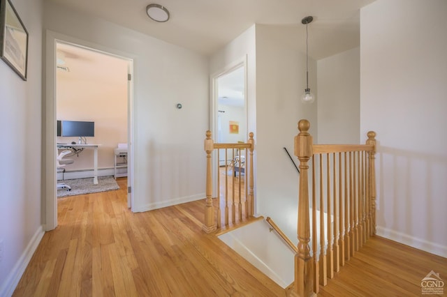 25 Joslen Pl, Hudson, NY 12534 - hall featuring an upstairs landing, wood finished floors, baseboard heating, and baseboards