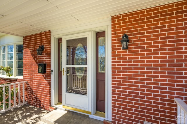 25 Joslen Pl, Hudson, NY 12534 - doorway to property with a porch and brick siding