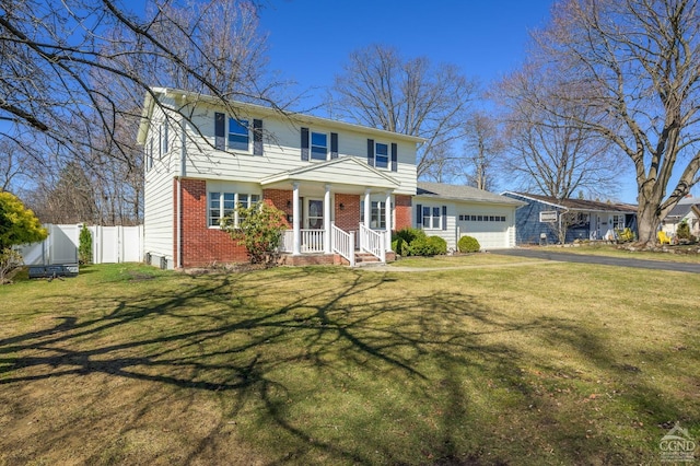 25 Joslen Pl, Hudson, NY 12534 - traditional-style house with brick siding, an attached garage, and asphalt driveway