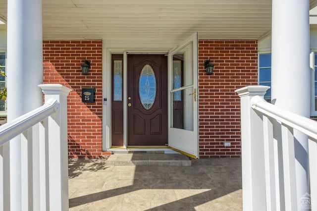 25 Joslen Pl, Hudson, NY 12534 - view of exterior entry with brick siding and a porch