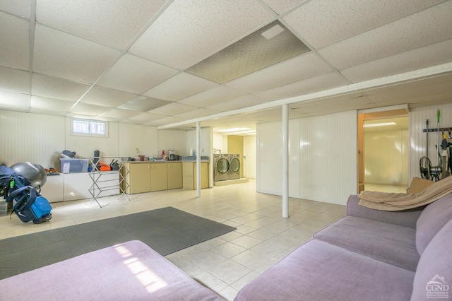 25 Joslen Pl, Hudson, NY 12534 - basement with washing machine and clothes dryer, a paneled ceiling, and light tile patterned floors