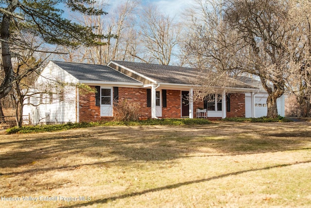 single story home with a front yard, brick siding, and a garage