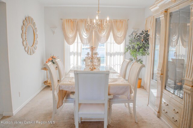 dining space with a notable chandelier and light carpet